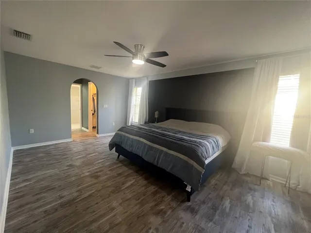 a bedroom with a bed and window