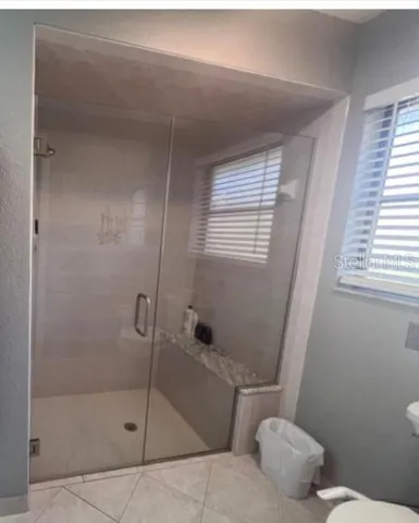 a bathroom with a toilet a sink and shower