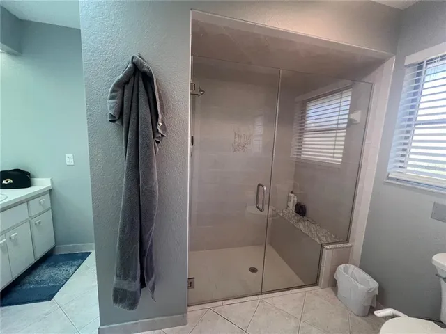 a bathroom with a toilet a sink and shower