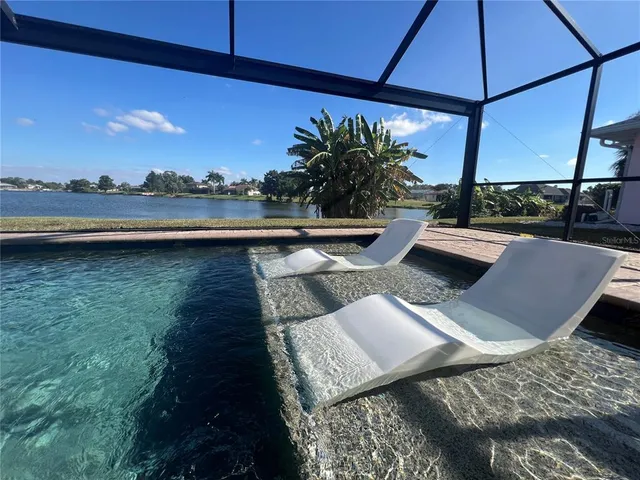 a view of a lake with houses in the back