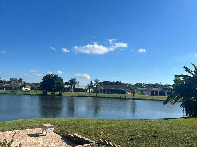 a view of a lake in front of a house with a lake