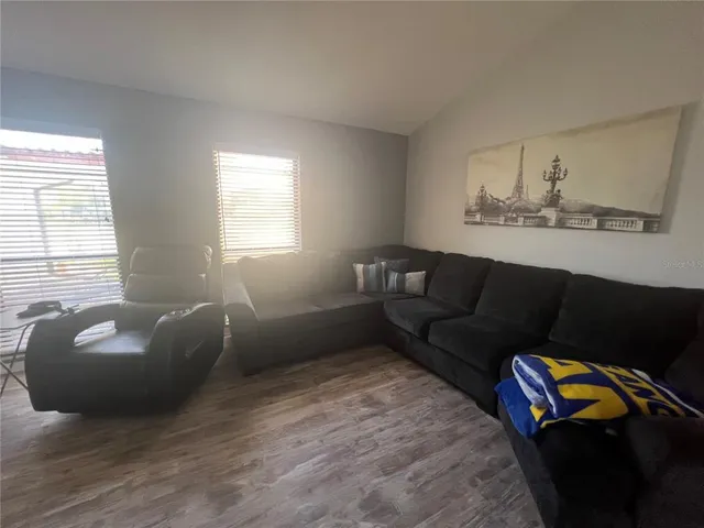a living room with furniture and a window