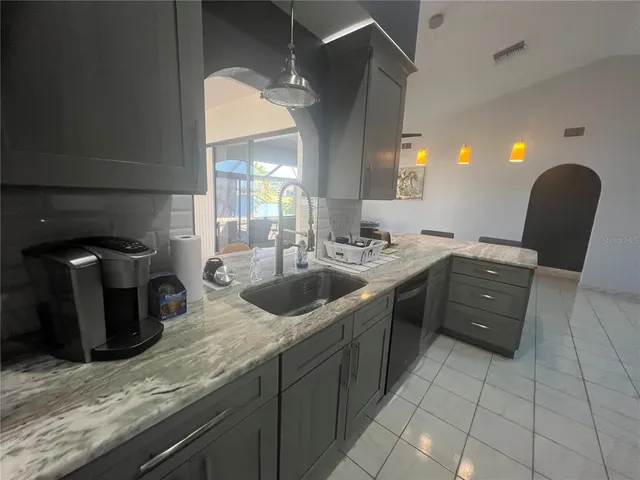a kitchen with stainless steel appliances granite countertop a sink and a cabinets