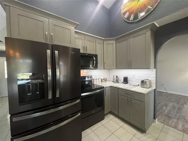 a kitchen with a sink and stainless steel appliances
