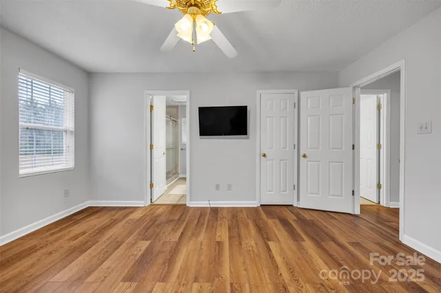 a bathroom with a granite countertop sink a large mirror and a bathtub