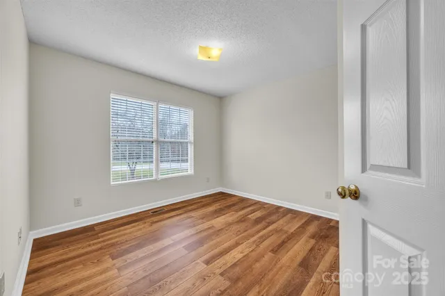 a view of a room with wooden floor
