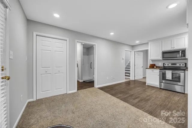 a bathroom with a granite countertop toilet sink and mirror