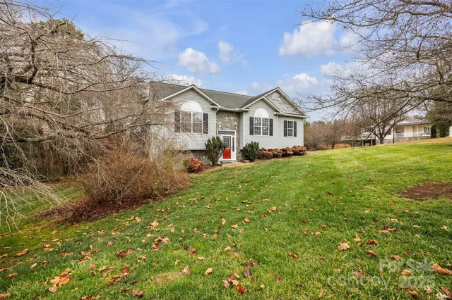 a view of house with yard