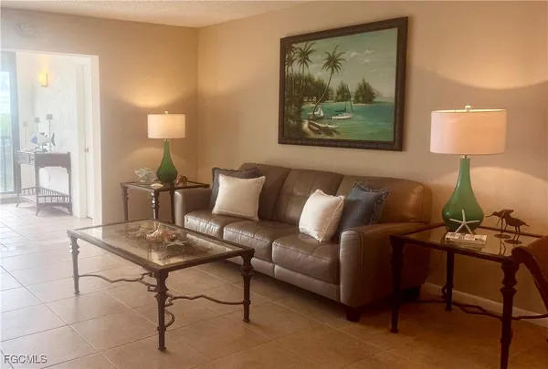 a living room with furniture and a lamp