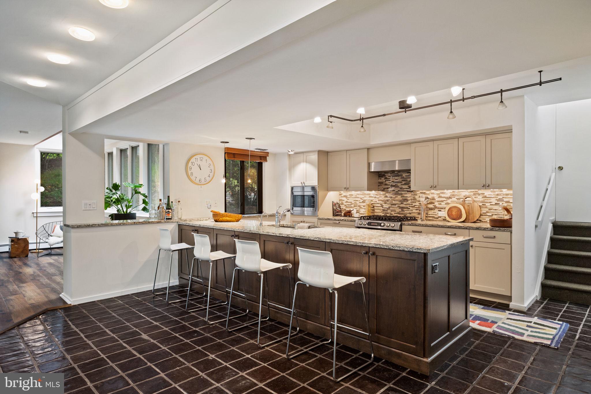 175 Old Gulph Road Wynnewood, PA 19096 - Photo 39 of 87 a kitchen with a dining table chairs and white appliances