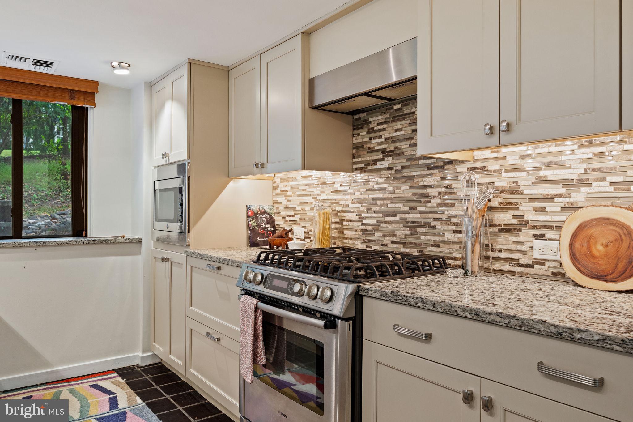 175 Old Gulph Road Wynnewood, PA 19096 - Photo 42 of 87 a kitchen with granite countertop a stove and a sink