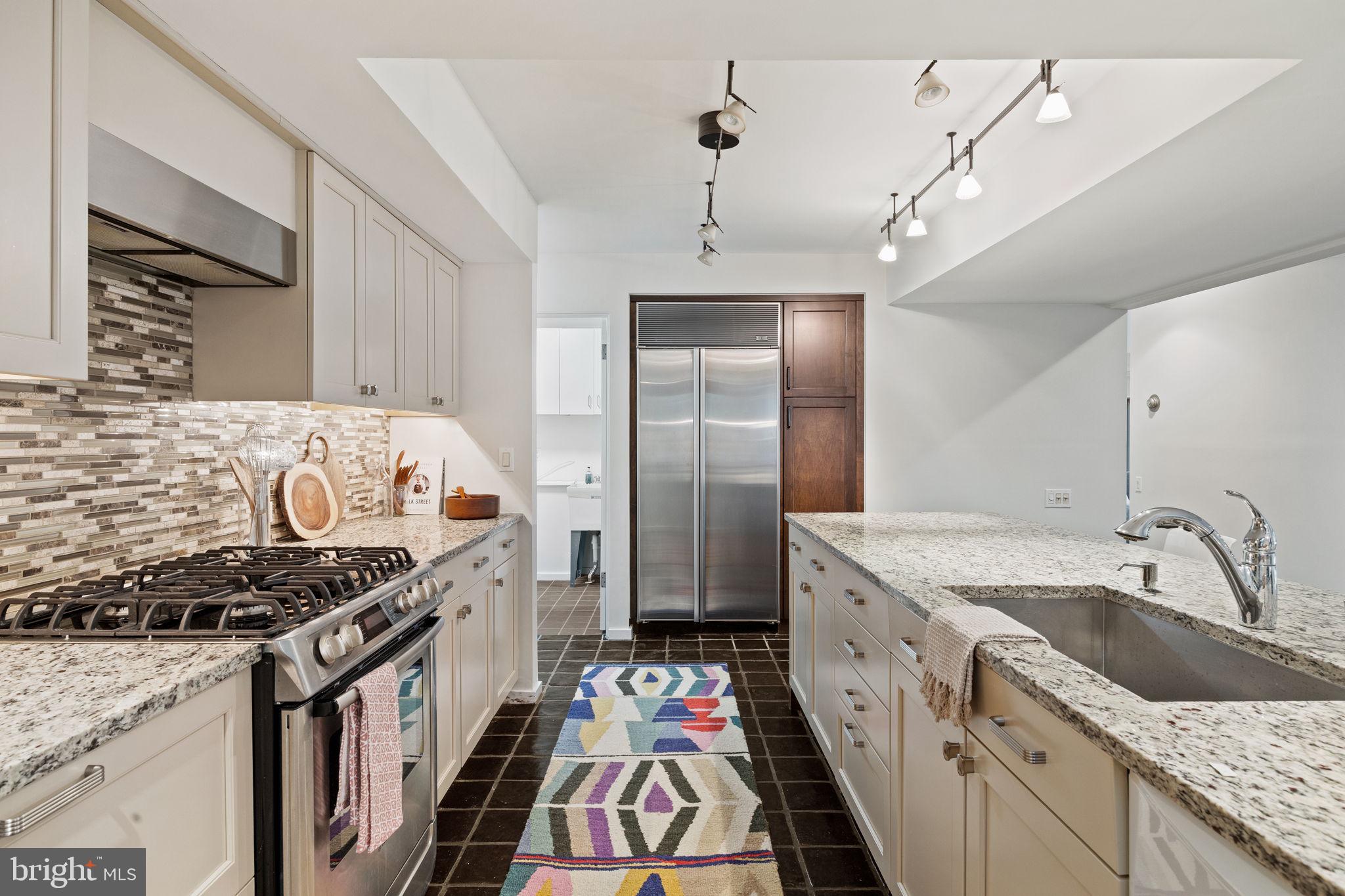 175 Old Gulph Road Wynnewood, PA 19096 - Photo 44 of 87 a kitchen with granite countertop a sink stove and refrigerator