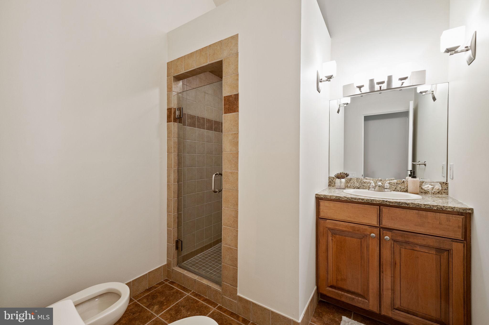 175 Old Gulph Road Wynnewood, PA 19096 - Photo 53 of 87 a bathroom with a granite countertop sink a toilet and a mirror