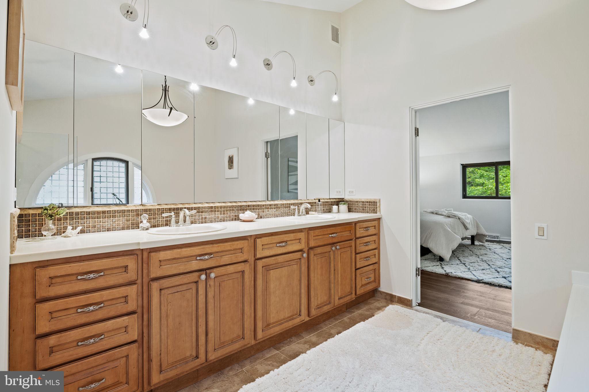 175 Old Gulph Road Wynnewood, PA 19096 - Photo 61 of 87 a bathroom with a double vanity sink and a mirror