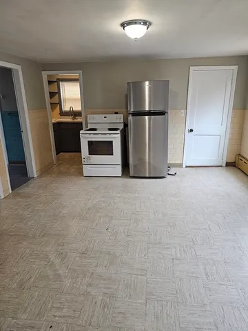 a view of a kitchen with a sink stove refrigerator and microwave