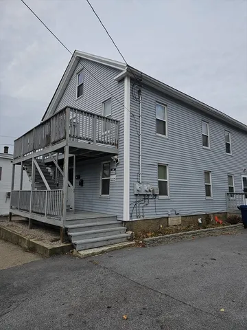a view of a house with wooden fence