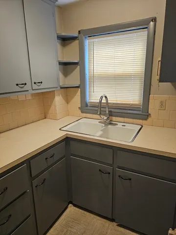 a kitchen with a sink and cabinets
