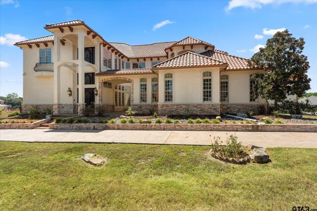 a front view of a house with swimming pool and yard