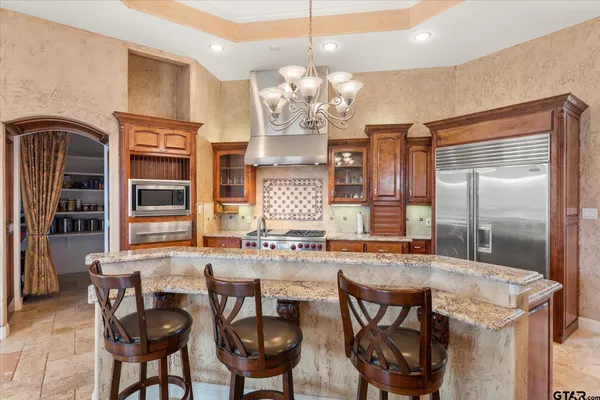 a dining table with chairs and chandelier