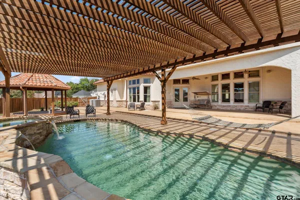 a view of a swimming pool with sitting area