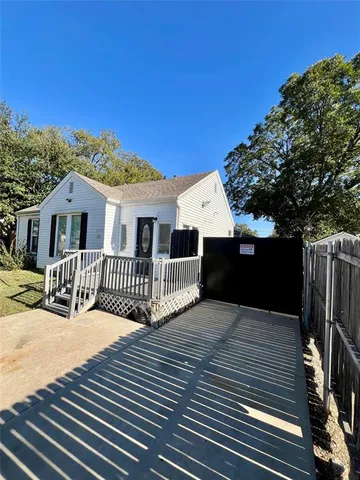 a view of a house with a wooden deck