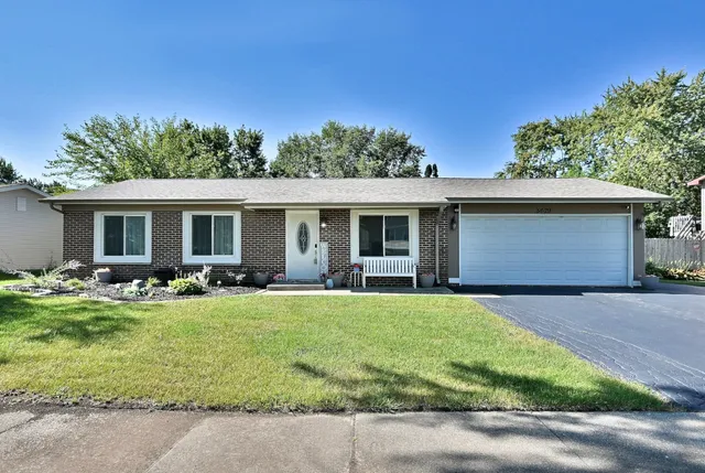 a front view of house with yard and outdoor seating