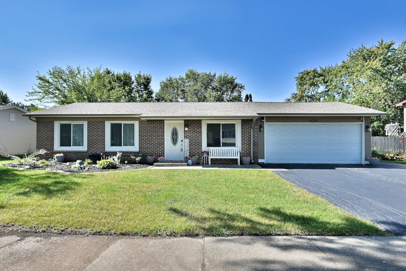 a front view of house with yard and outdoor seating