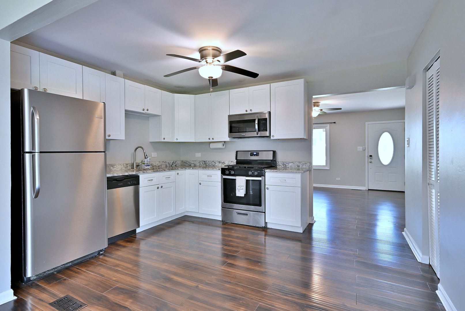 5629 Crestwood Road Matteson, IL 60443 - Photo 4 of 20 a kitchen with kitchen island granite countertop stainless steel appliances cabinets a sink and a wooden floor