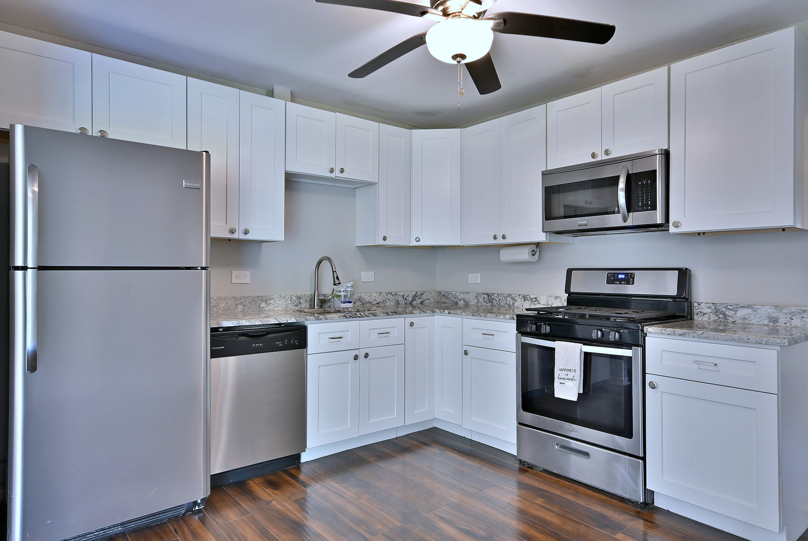 5629 Crestwood Road Matteson, IL 60443 - Photo 5 of 20 a kitchen with stainless steel appliances granite countertop a stove a refrigerator and a microwave