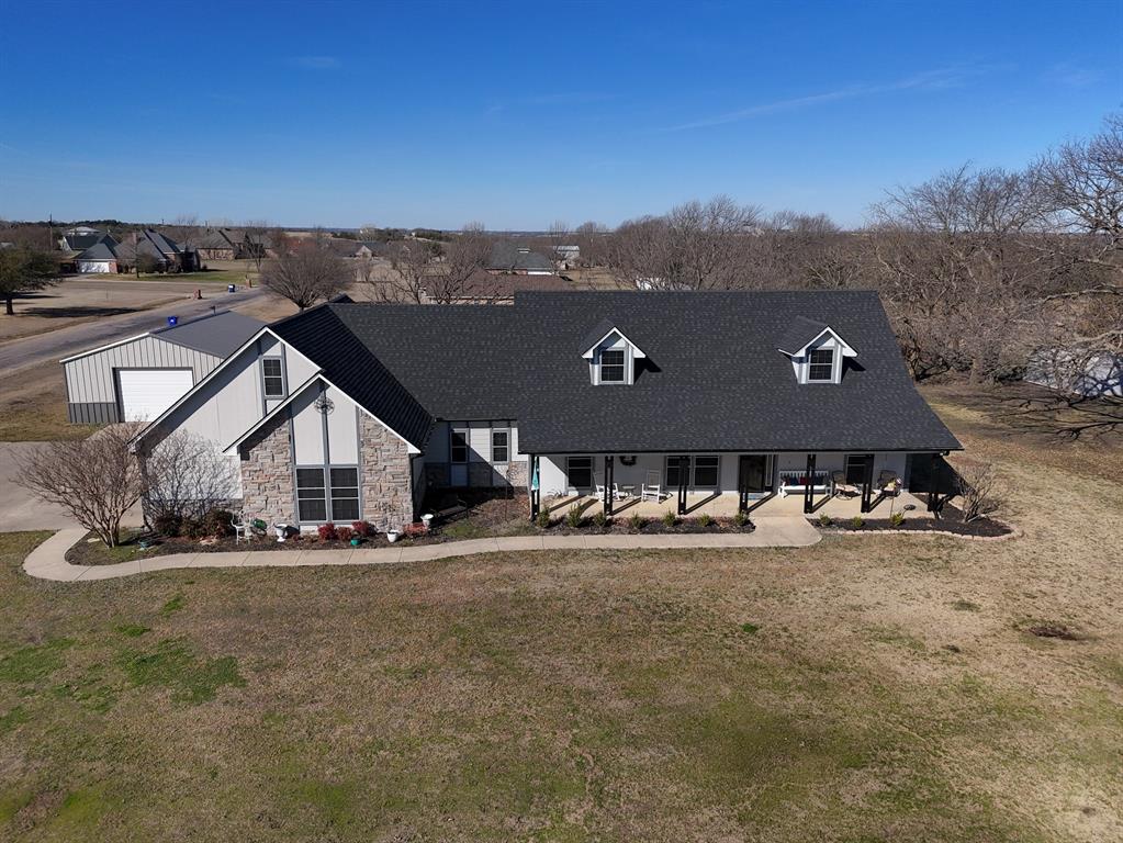 an aerial view of a house with a big yard