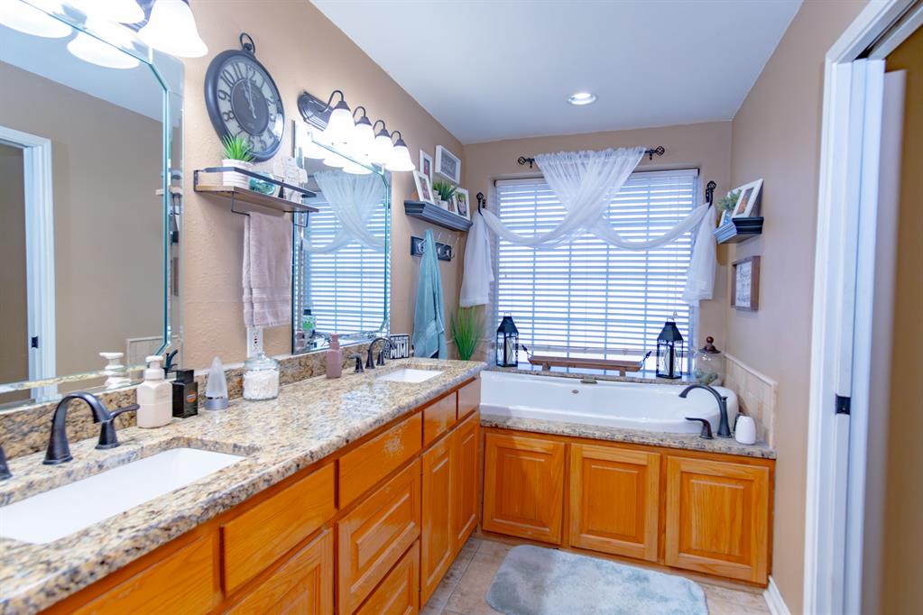 733 Ridgeview Drive Sherman, TX 75090 - Photo 24 of 40 a bathroom with a granite countertop double vanity sink and a mirror