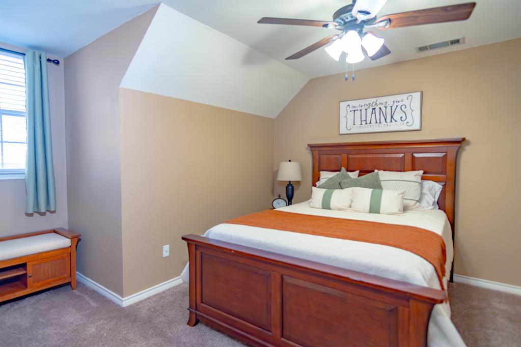 733 Ridgeview Drive Sherman, TX 75090 - Photo 28 of 40 a bedroom with a bed and a chandelier