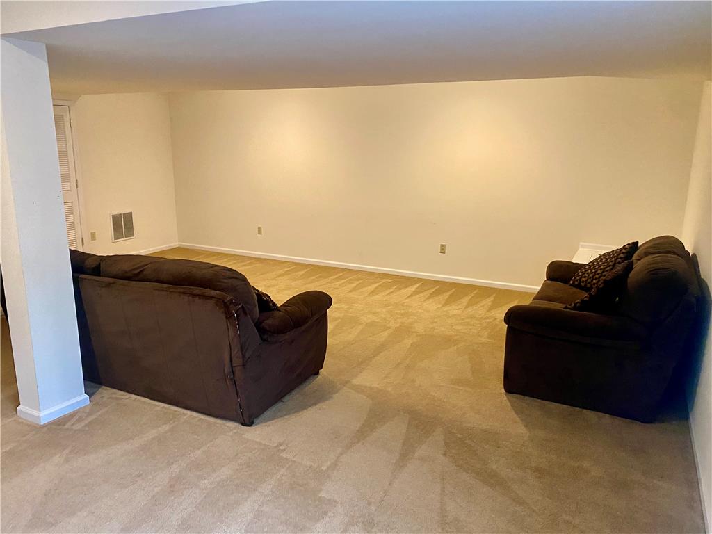 5494 Spring Ridge Drive West Macungie, PA 18062 - Photo 13 of 14 Plush wall-to-wall carpeting and smooth neutral walls anchor this versatile lower-level living area.