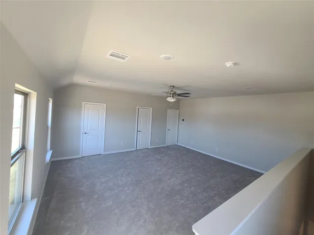 an empty room with a empty space and windows