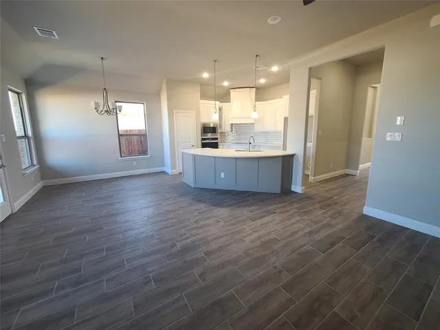 a large room with wooden floor and windows