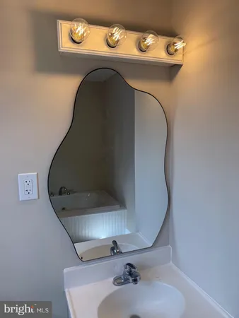 a bathroom with a sink and mirror