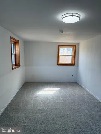 a view of a livingroom with wooden floor and stairs