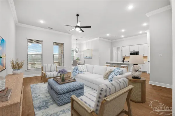a living room with furniture and a chandelier