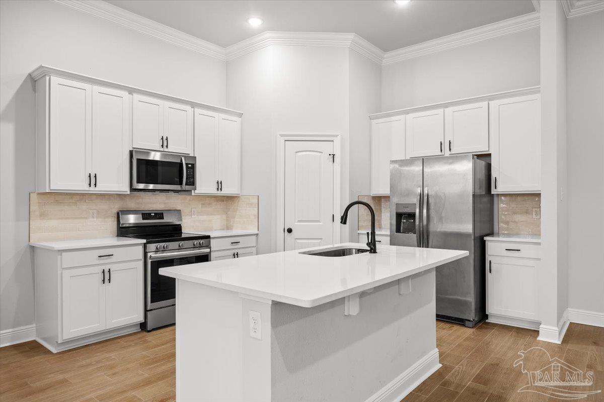 5362 Adeline Circle Pace, FL 32571 - Photo 11 of 40 a kitchen with appliances a sink cabinets and a counter top space
