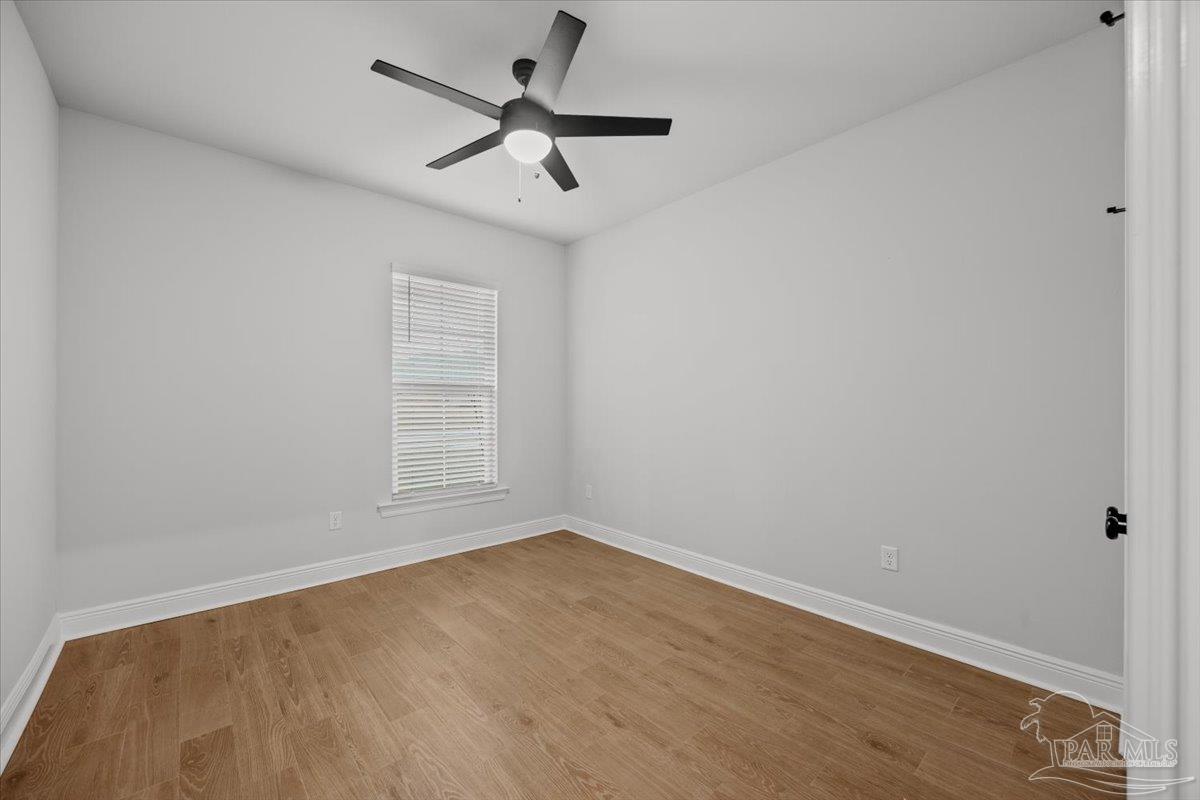 5362 Adeline Circle Pace, FL 32571 - Photo 17 of 40 an empty room with a window and a fan