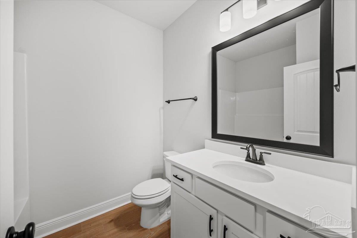 5362 Adeline Circle Pace, FL 32571 - Photo 19 of 40 a bathroom with a granite countertop sink vanity mirror and toilet