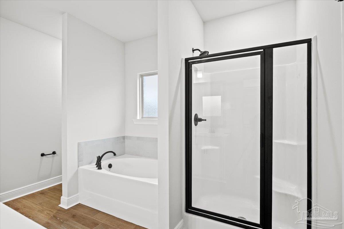 5362 Adeline Circle Pace, FL 32571 - Photo 23 of 40 a bathroom with a bathtub and a shower