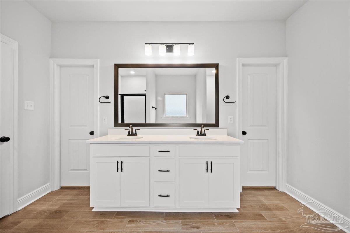 5362 Adeline Circle Pace, FL 32571 - Photo 25 of 40 a bathroom with a double vanity sink and a mirror