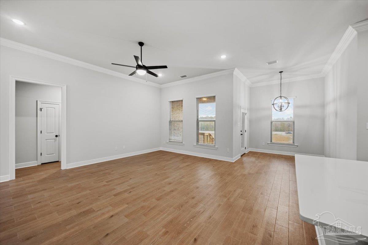 5362 Adeline Circle Pace, FL 32571 - Photo 6 of 40 a view of an empty room with window and wooden floor