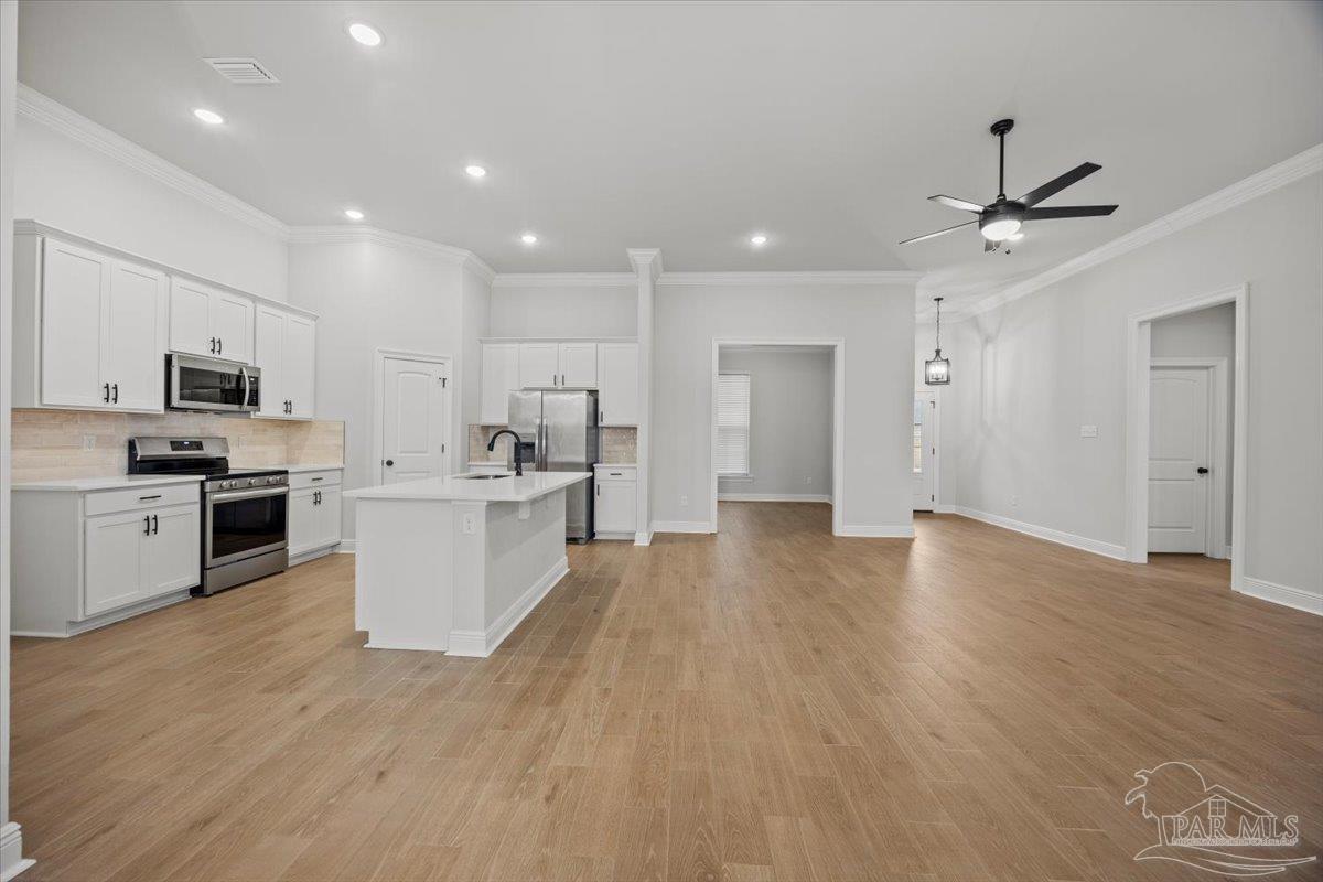 5362 Adeline Circle Pace, FL 32571 - Photo 7 of 40 a large kitchen with cabinets and stainless steel appliances