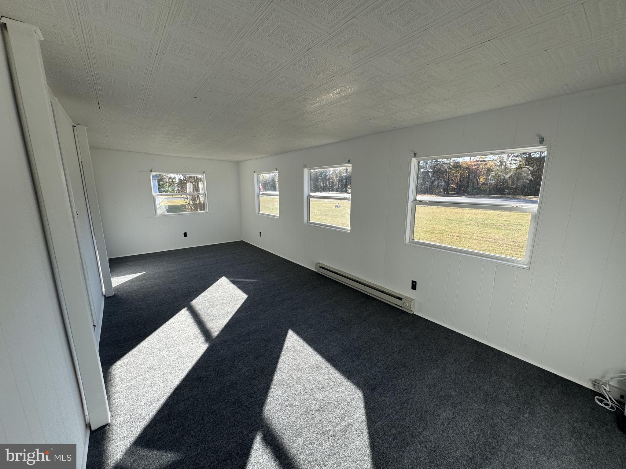 28659 Harmons Hill Road Millsboro, DE 19966 - Photo 13 of 16 a view of an empty room with glass door and a window