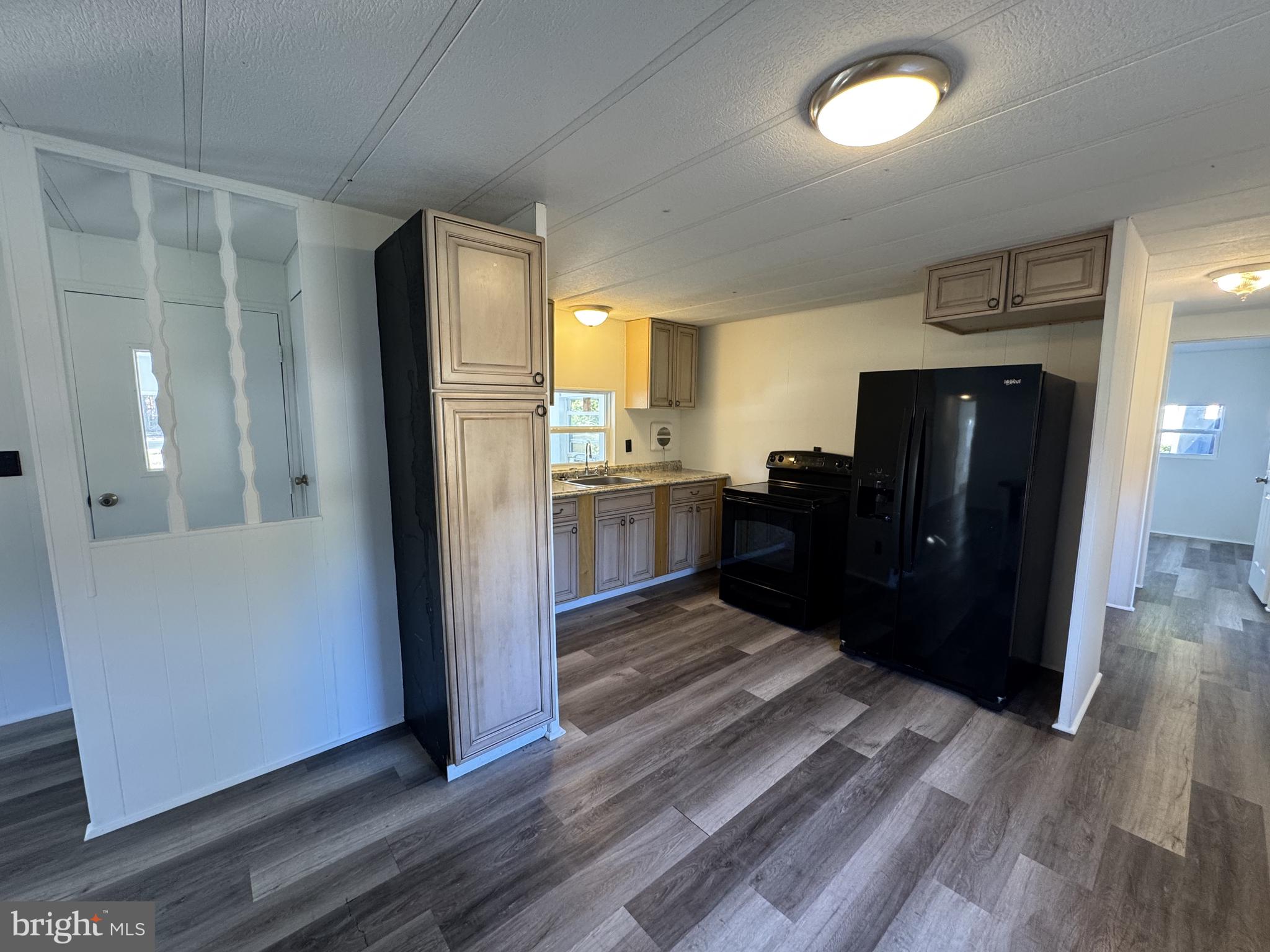 28659 Harmons Hill Road Millsboro, DE 19966 - Photo 5 of 16 a kitchen with stainless steel appliances granite countertop a refrigerator and a sink