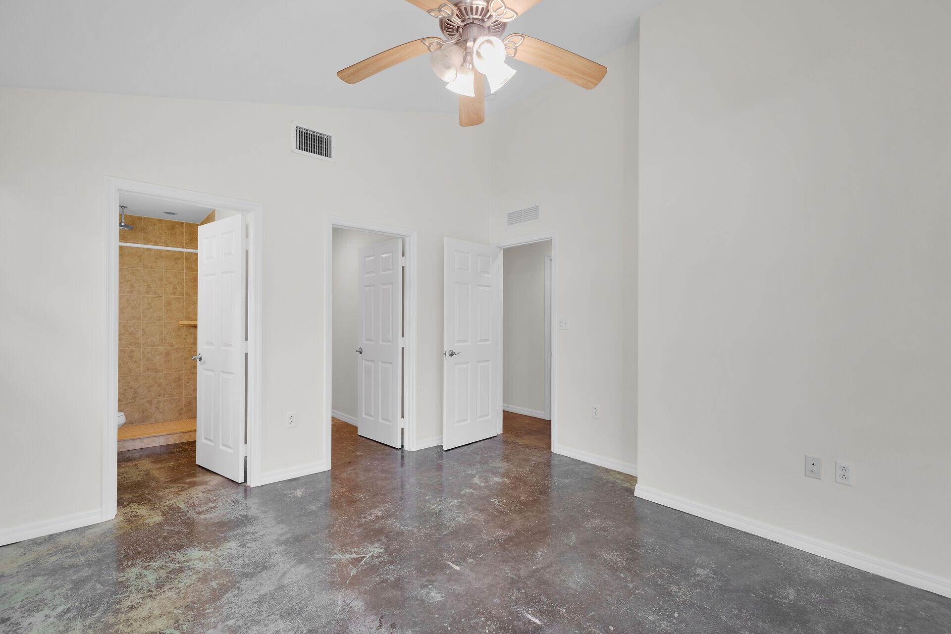 1018 Snapper Lane Key Largo, FL 33037 - Photo 7 of 24 an empty room with chandelier fan and windows