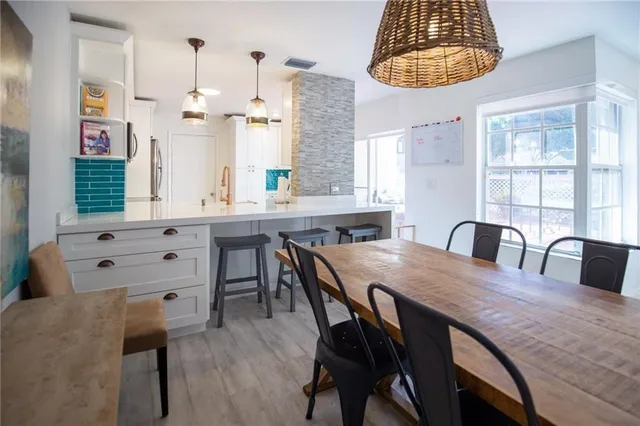 a view of dining table chairs and window
