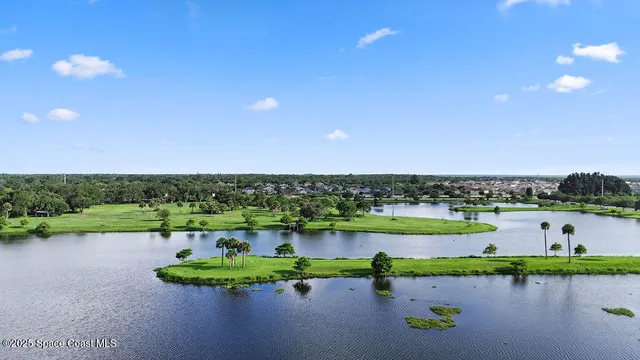 a view of a lake with houses in the back